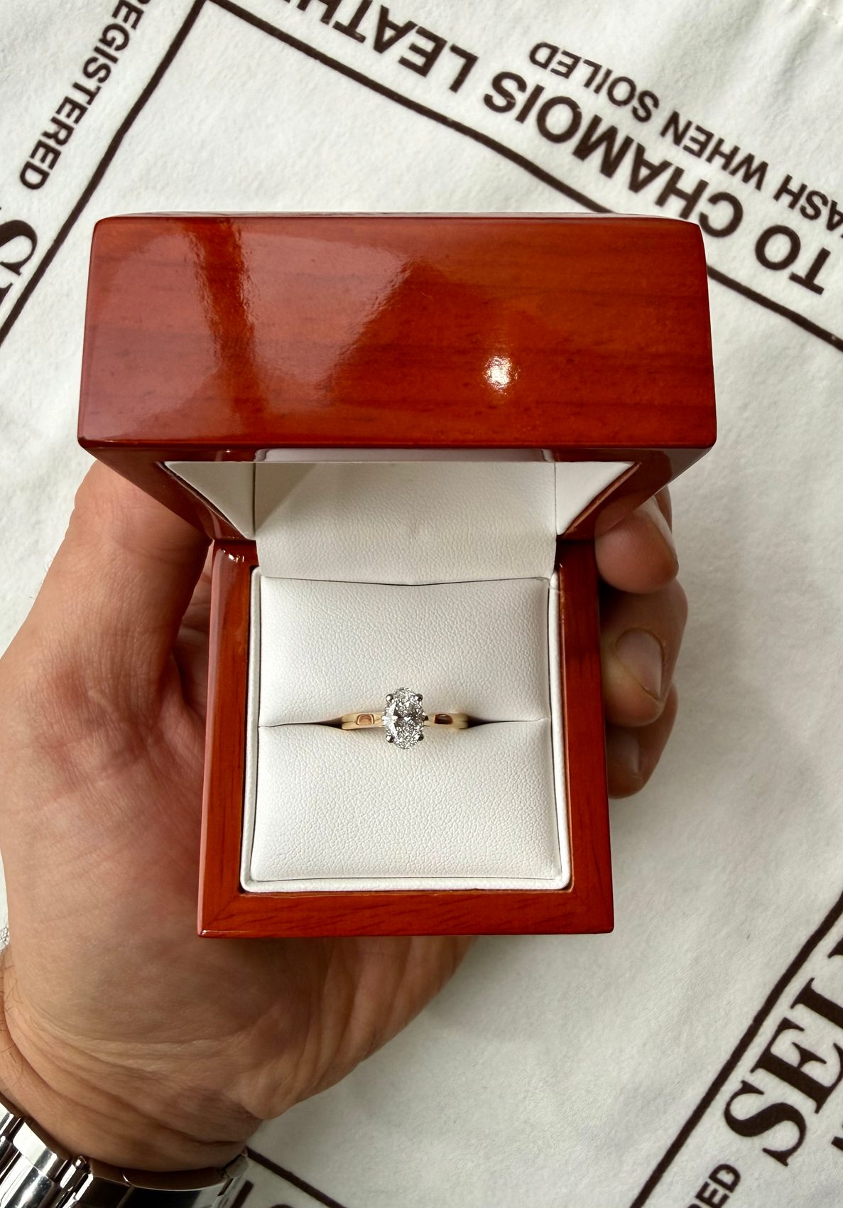 A marquise-cut diamond in 18ct yellow gold, set in a customer wood box.